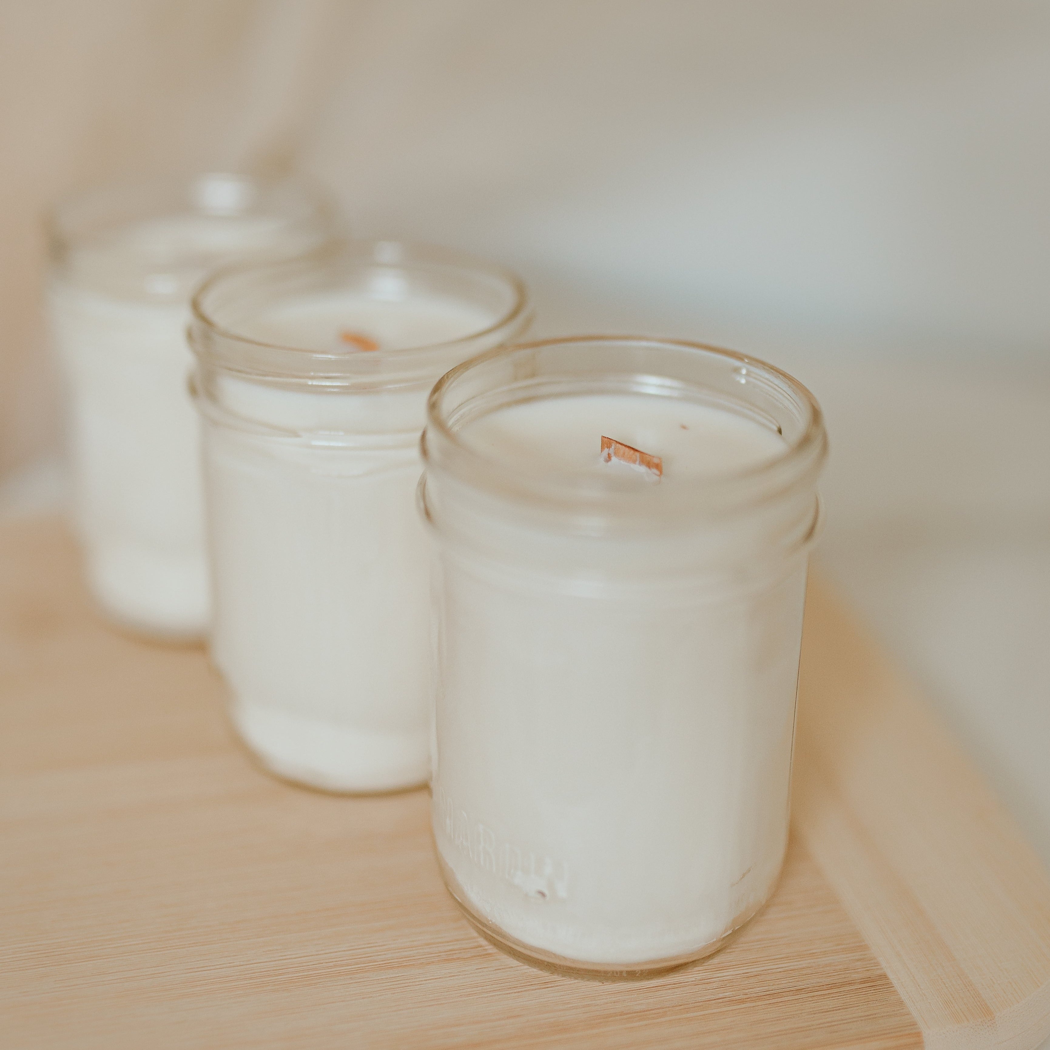 3 candle in a diagonal line on a wooden floor
