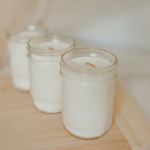 3 candle in a diagonal line on a wooden floor