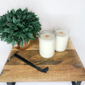 Coconut soy candles on wooden display with wick trimmer