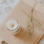 Load image into Gallery viewer, lit candle on wooden tray
