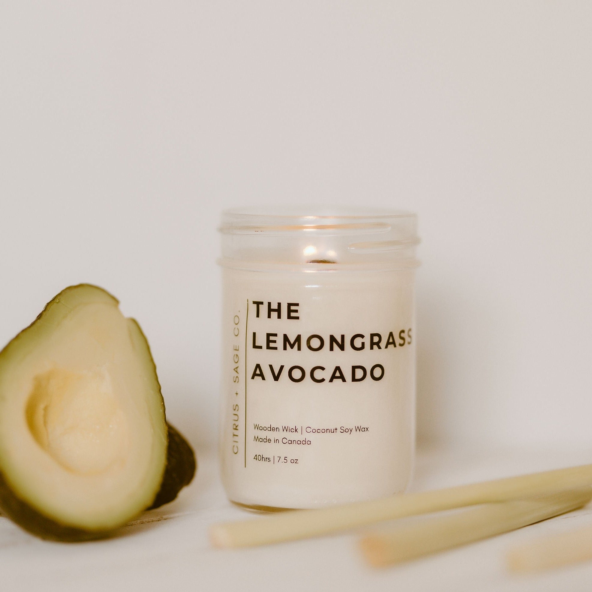 mason jar candle with avocado and lemongrass beside it