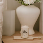 Load image into Gallery viewer, mason jar candle on table with white vase and flowers
