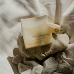 Load image into Gallery viewer, white &amp; orange swirl design bar soap on rocks
