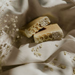 Load image into Gallery viewer, 2 oat bars of soap on satin sheet 
